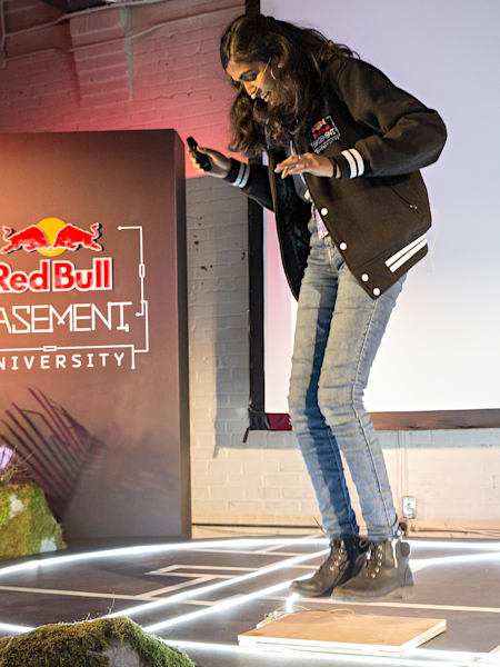 Nandhika Venkateswaran jumps on a panel to demonstrate the EnergyBrid system at the Red Bull Basement University World Finals in Toronto.