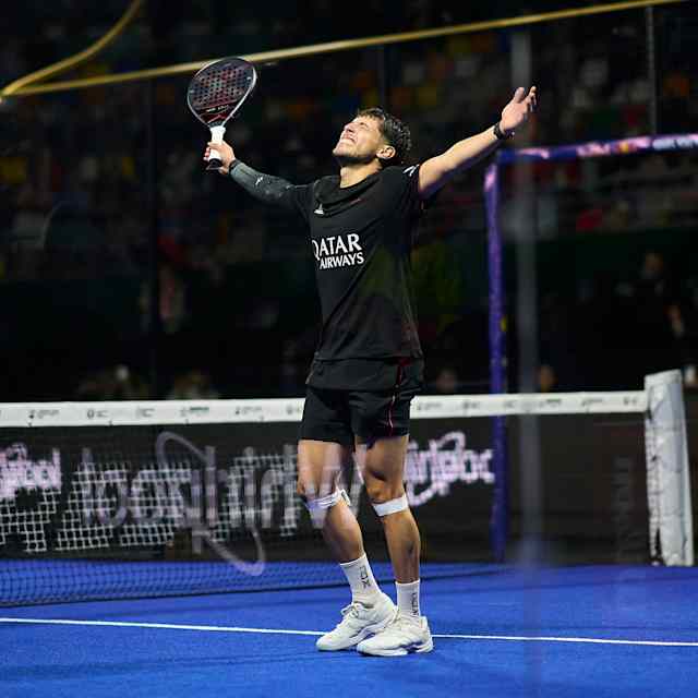Agustin Tapia raises his arms in triumph during the semi-finals of the Buenos Aires Premier Padel P1 in Argentina, showing Red Bull's competitive spirit in June 2025