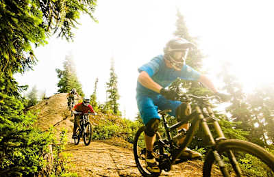 Riders follow each other down one of the trails at Whistler Bike Park in Canada