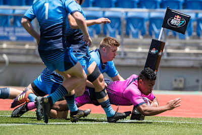 Rugby players score a try during a match.