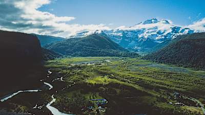 Looking across a valley towards a snow-capped mountain in Patagonia.