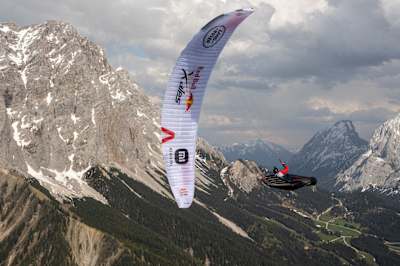 Red Bull X-Alps athlete Thomas Friedrich soars over Wagrain during the 2021 race.