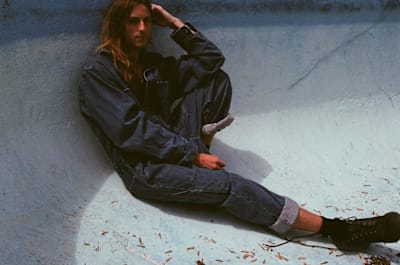 Mind Bath poses in a denim suit