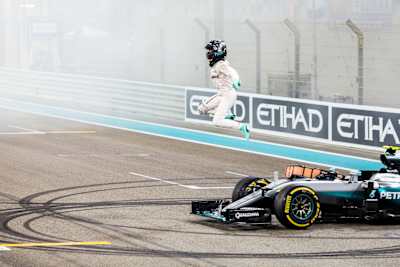 Nico Rosberg vaults from the car in celebration