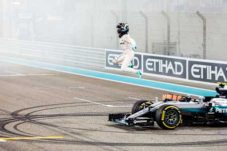 Nico Rosberg vaults from the car in celebration