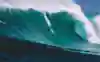 Grant Baker takes the drop while surfing at Jaws in Maui.
