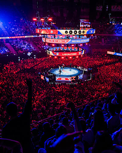 A packed crowd cheers at the Red Bull Batalla World Final 2024 in Madrid, Spain, where freestyle MCs battle under vibrant lights, capturing Red Bull's legendary high-energy atmosphere