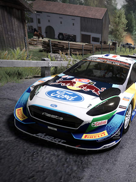 A screenshot of a Red Bull vehicle driving past a barn in WRC 10