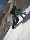 A member of Leo Houlding's team scales an ice wall in Antarctica.