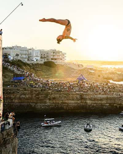 Nikita Fedotov dives during the first competition day of the third stop of the 2024 Red Bull Cliff Diving World Series in Polignano a Mare, Italy on June 28, 2024. 