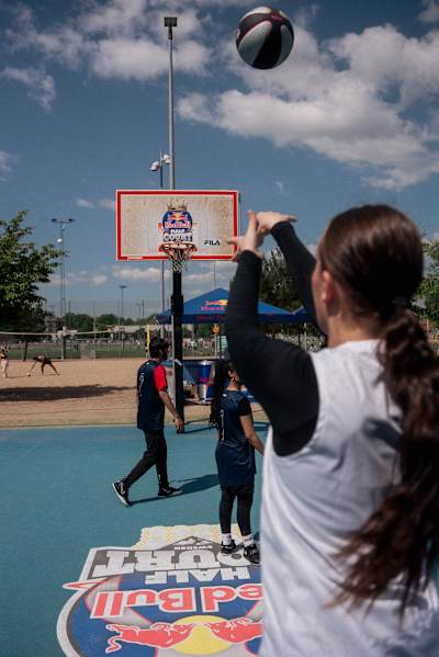 A street basketball player scoring a three-pointer.