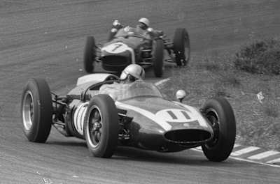 A black and white image of an F1 racing car from the 1950s.