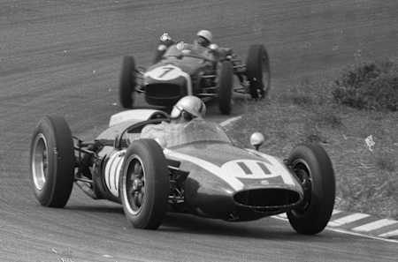 A black and white image of an F1 racing car from the 1950s.