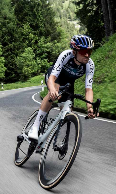 Thomas Pidcock takes a bend at 100kph on the twisting Rossfeld Panoramastrasse in southern Germany in June 2025.
