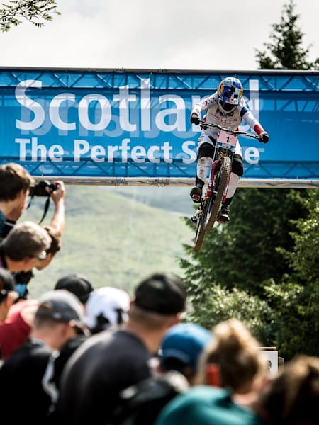 Myriam Nicole jumping through the Scotland arch during Rd2 of the 2018 UCI DH World Cup in Fort William, Scotland on June 3, 2018.
