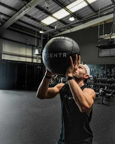 HYROX athlete Jake Dearden prepares to throw a wall ball during a CENTR training session.