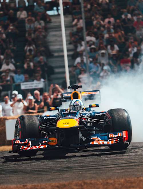 A Red Bull F1 car drifts around the track at the 2025 Goodwood Festival of Speed in the UK