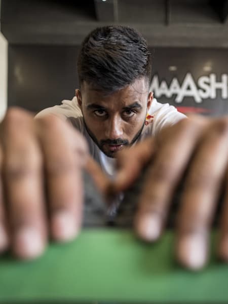 Indian hockey team captain Manpreet Singh workouts out in a gym.