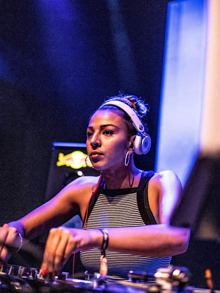 T-Sia behind the decks watching the action on the dancefloor at the Red Bull BC One Camp Zurich in 2018.