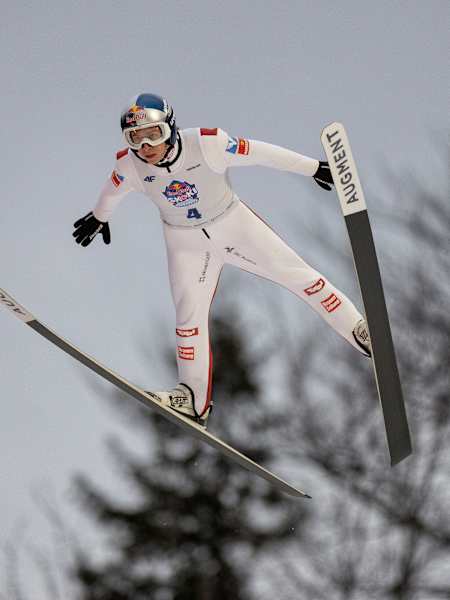 A thrilling moment as Daniel Tschofenig takes flight during Red Bull Skoki w Punkt in Zakopane, Poland on April 5, 2025, capturing the adrenaline and daring of elite ski jumping
