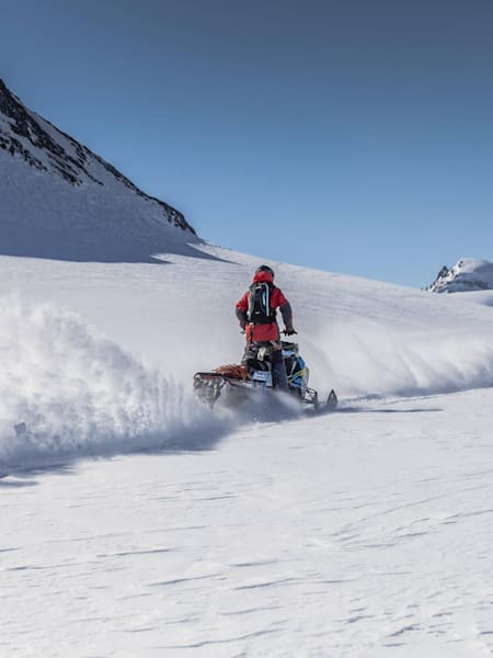John Jackson and Eric Jackson snowmobile in Whistler, Canada.