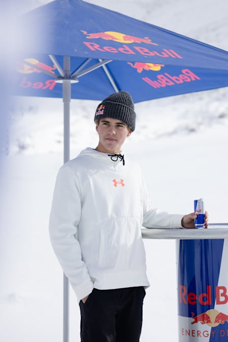 Nico Porteous standing outside with a Red Bull can in his hand