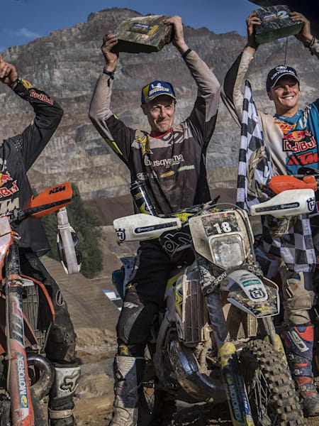 Manuel Lettenbichler of Germany, Graham Jarvis of the UK and Jonny Walker of the UK celebrate at the Erzbergrodeo Red Bull Hare Scramble at the Erzberg in Eisenerz, Austria on June 3, 2018