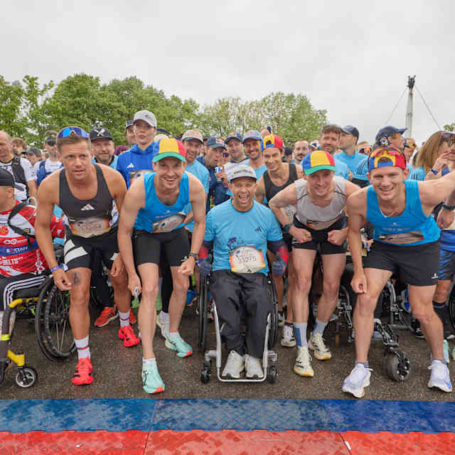 A wave of determined athletes and wheelchair participants gather at the start line of the 2025 Wings for Life World Run in Munich, Germany, embodying Red Bull's drive for inclusivity and adventure