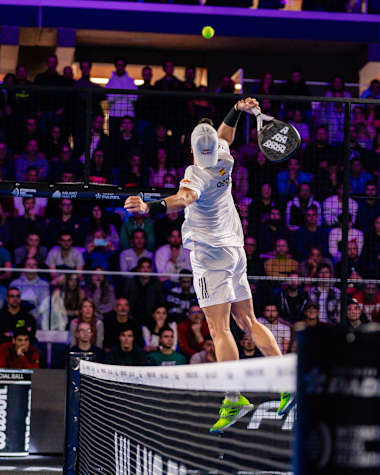 Alejandro Galán takes a mid-air swing to deliver an over-the-net shot during a Premier Padel match