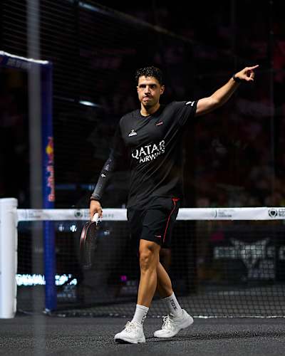 Agustin Tapia is captured in action on July 6, 2025 at the Bordeaux Premier Padel P2 finals in France, with Red Bull branding powering the energetic atmosphere
