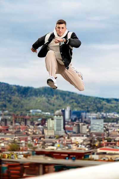 Simon Ehammer jumps towards the camera in casual clothing during a photoshoot for the Red Bulletin