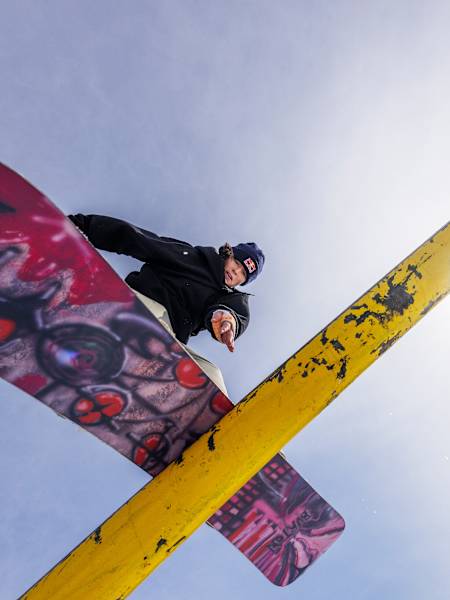 Grace Warner executes a boardslide at the 2024 Red Bull Slide In Tour in Trollhaugen Ski Area, Dresser, Wisconsin.