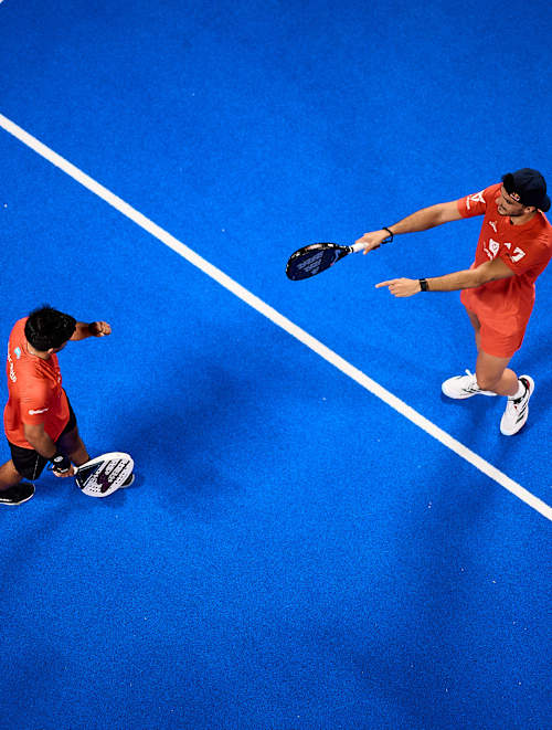Federico Chingotto and Alejandro Galán compete in the final of the Motorola Razr Miami Premier Padel P1 in 2025, showcasing dynamic teamwork on a vibrant blue court