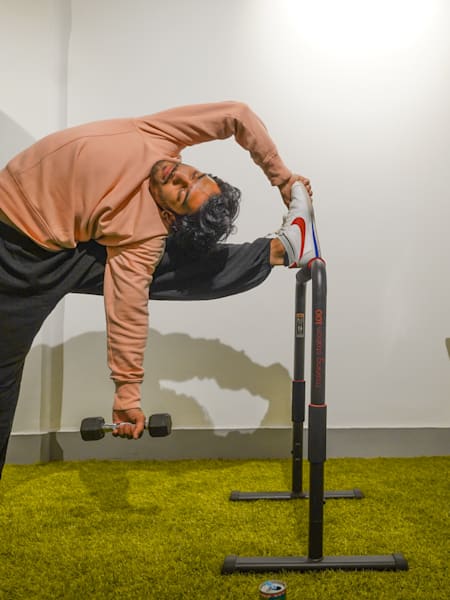Fitness trainer Karan Bagri performs a Shaolin stretch in his home gym.