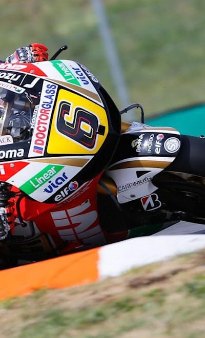 MotoGP™ rider Stefan Bradl on his motorcycle on a curve.