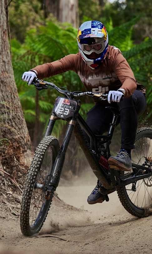Brook Macdonald launches through a forest trail during Red Bull Hardline practice at Maydena Bike Park, Australia.
