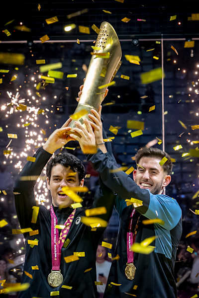 In 2024, Jorge Nieto and Jon Sanz celebrate their Premier Padel Finals victory in Barcelona, Spain, triumphantly raising a trophy amidst confetti.