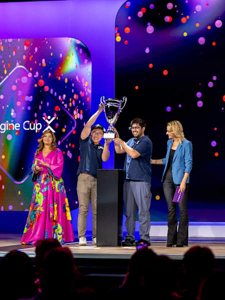 Red Bull Basement US National Winners Team Argus are named Microsoft Imagine Cup 2025 World Champions. From left, Dona Sarkar (Microsoft), Daniel Kim and Arjun Oberoi (Argus), Annie Pearl (Microsoft).