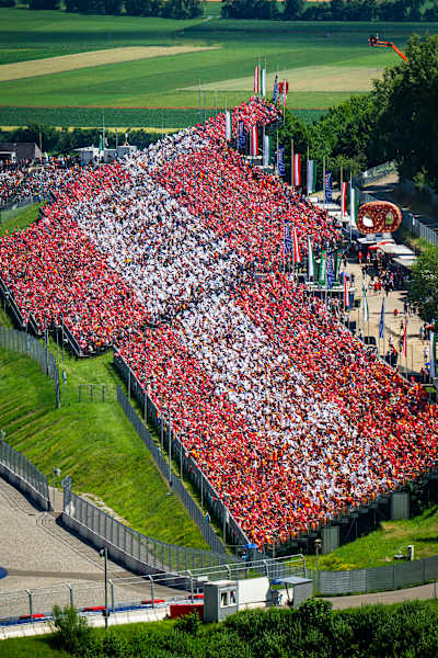 Spectators display a tifo of the Austrian flag during the FIA Formula One World Championship at the Red Bull Ring in Spielberg, Austria in 2025. 