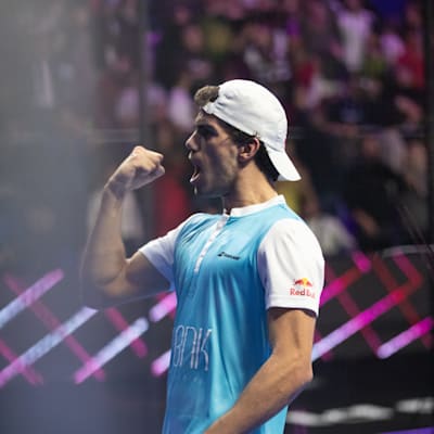 A player celebrates a point on the court at a Premier Padel event.