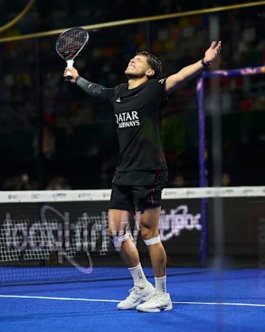 Agustin Tapia raises his arms in triumph during the semi-finals of the Buenos Aires Premier Padel P1 in Argentina, showing Red Bull's competitive spirit in June 2025