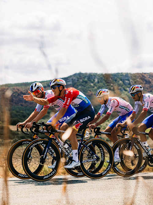 Team Red Bull - BORA - hansgrohe cycle near Montpellier during the Tour de France in 2025.