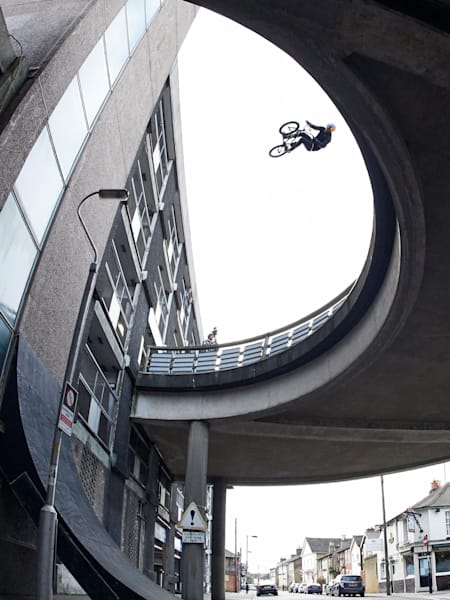 BMX rider Sebastian 'Bas' Keep drops in off a bridge road for his Walls project in Croydon, England