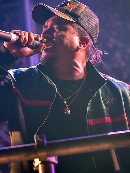 A photograph of Indian rapper, Divine, performing on stage.