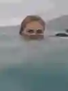 Ivy Miller poses for a portrait image with just her head above water.