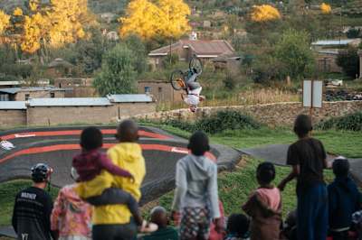 MTB rider Matt Jones tricks out on a pump track course in Roma, Lesotho.