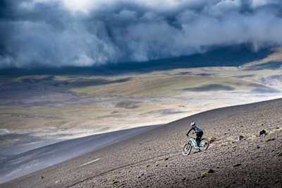Finn Isles rides down volcanic landscape in Ecuador.