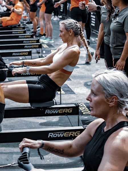 Competitors take on a rowing challenge during a HYROX fitness event