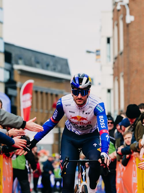 Tim van Dijke of Red Bull – BORA – hansgrohe greets fans during the 78th Kuurne - Brussel - Kuurne cycling event in Belgium. 