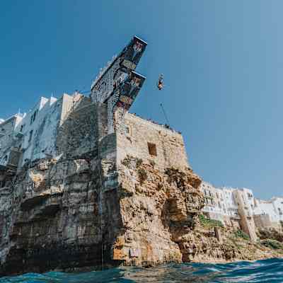 In 2024, James Lichtenstein plunges from Polignano a Mare's iconic cliff during the Red Bull Cliff Diving World Series event